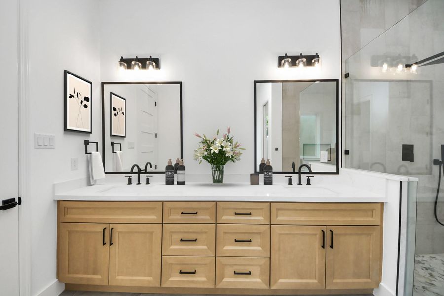 Primary bathroom w/ dual vanities. Primary bathroom w/ dual vanities.