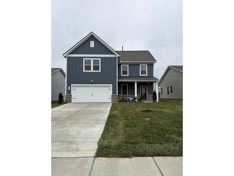 Front exterior of a new home in Sage Farms, White House, TN, highlighting curb appeal (Image 1).