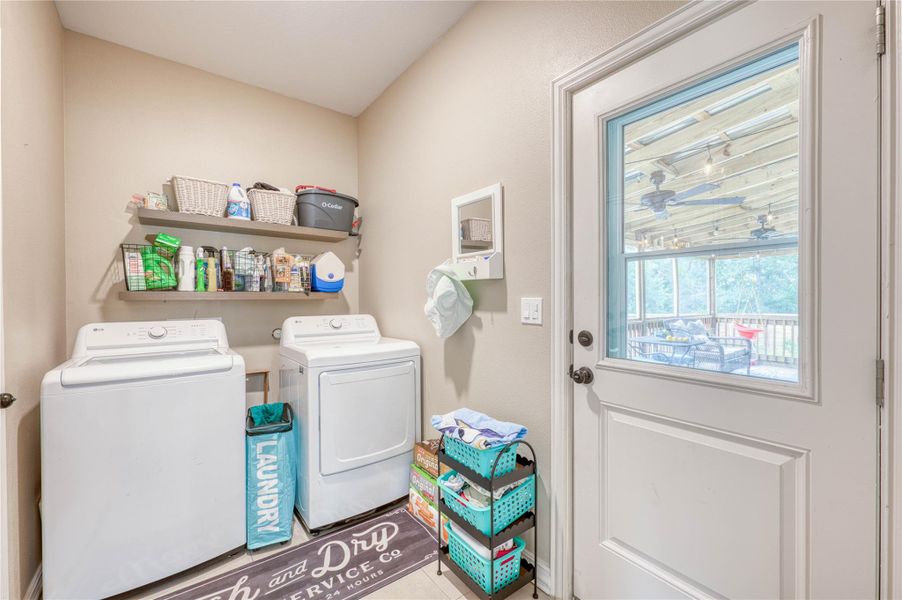 Dedicated laundry space featuring a white top-load washer and front-load dryer