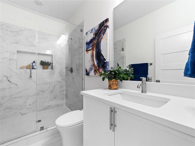 Full bathroom with marble finish flooring, vanity, and a marble finish shower