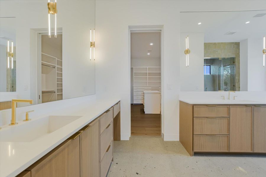Bathroom featuring a spacious closet, two vanities, recessed lighting, and a shower stall