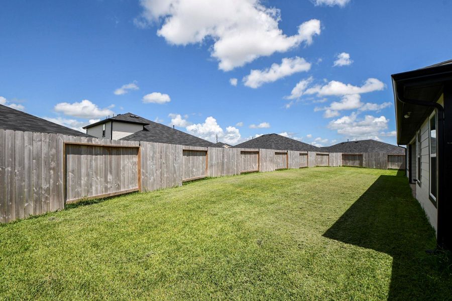 Spacious backyard with a well-maintained lawn.