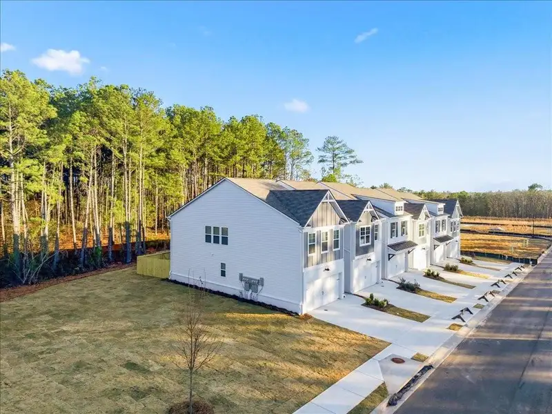 Front exterior of a new home in Shoals Crossing, Conyers, GA, highlighting curb appeal (Image 1). Front exterior of a new home in Shoals Crossing, Conyers, GA, highlighting curb appeal (Image 1).