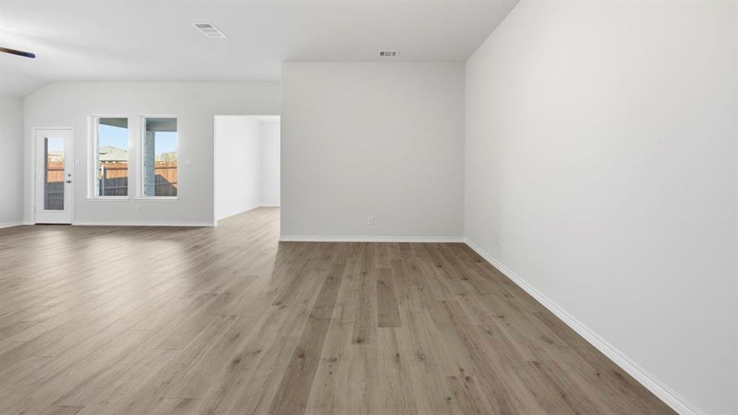 Empty room with light wood-type flooring and a ceiling fan
