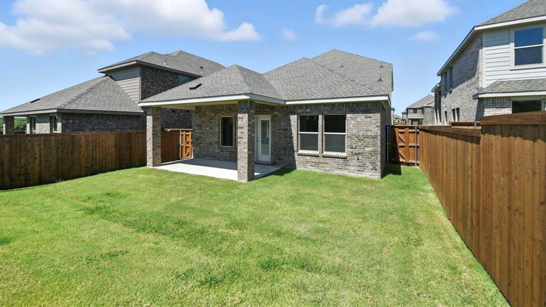 Back of property featuring brick siding, a patio, a shingled roof, and a fenced backyard Back of property featuring brick siding, a patio, a shingled roof, and a fenced backyard