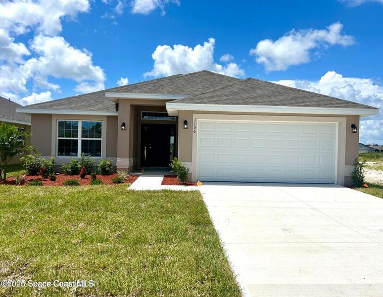 Front exterior of a new home in St. John Preserve, Palm Bay, FL, highlighting curb appeal (Image 1). Front exterior of a new home in St. John Preserve, Palm Bay, FL, highlighting curb appeal (Image 1).