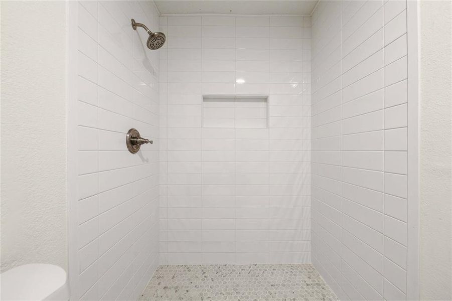 Full bathroom with toilet and a stall shower Full bathroom with toilet and a stall shower