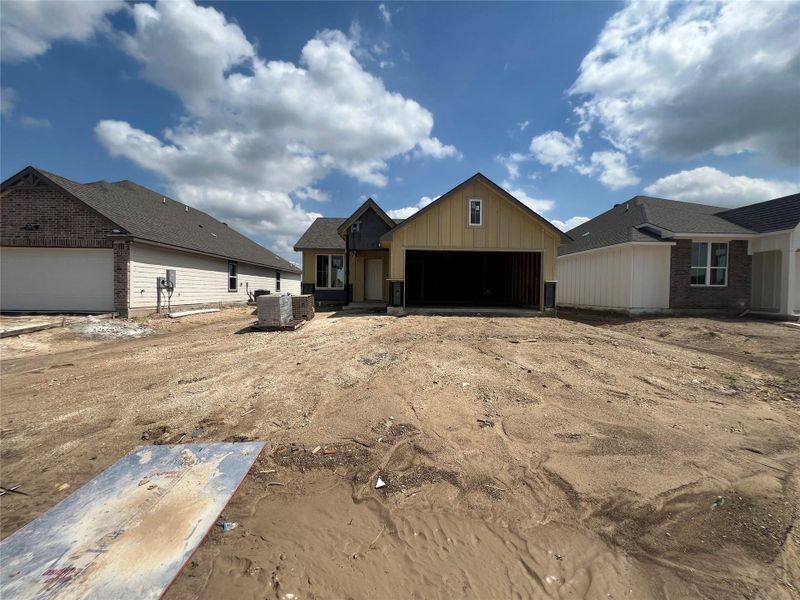 Two contemporary residences under construction, showcasing diverse architectural elements and roofing.