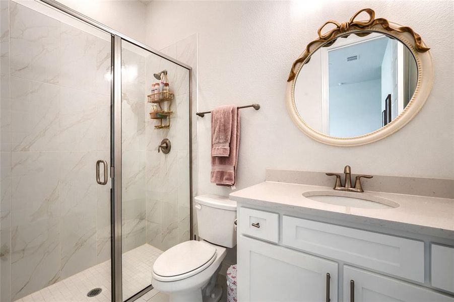 Bathroom with vanity and a shower stall