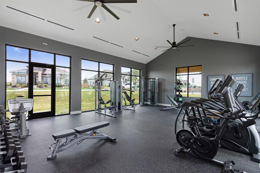 Gym featuring a high ceiling and a ceiling fan