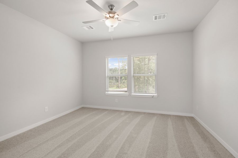 A room with a ceiling fan and a window.