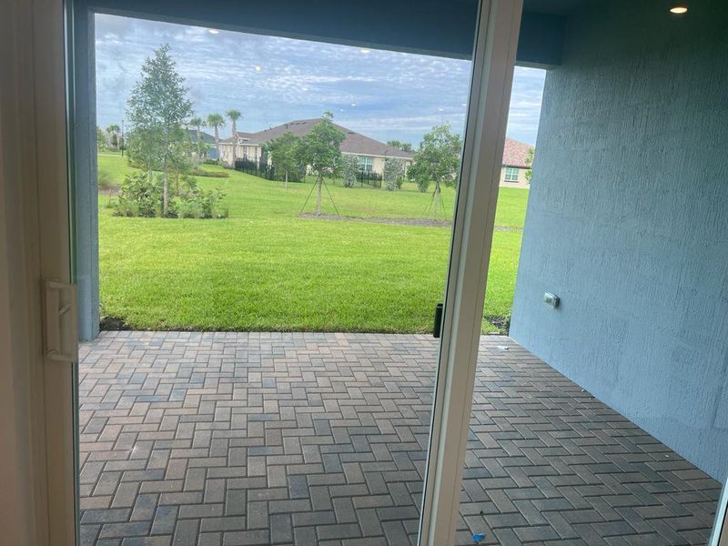Exterior details and patio area of a home in Arden: The Twin Homes Collection, Loxahatchee (Image 3).