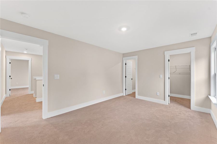 This spacious room features neutral tones and ampl
