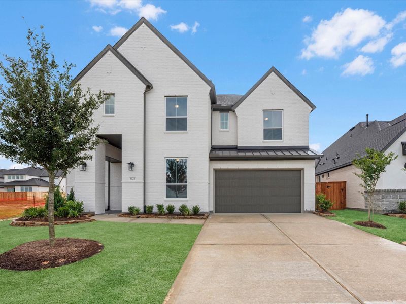 Front exterior of a new home in Pecan Ridge, Fulshear, TX, highlighting curb appeal (Image 2). Front exterior of a new home in Pecan Ridge, Fulshear, TX, highlighting curb appeal (Image 2).