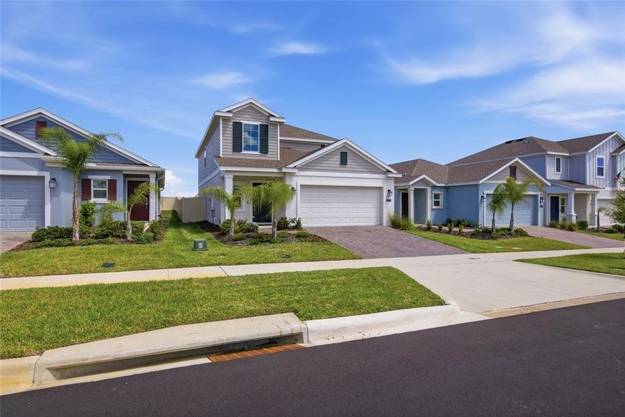 Front exterior of a new home in Wellness Ridge, Clermont, FL, highlighting curb appeal (Image 26).