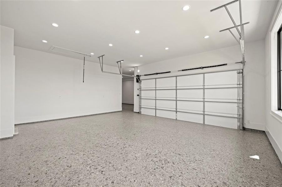 Garage featuring recessed lighting and baseboards