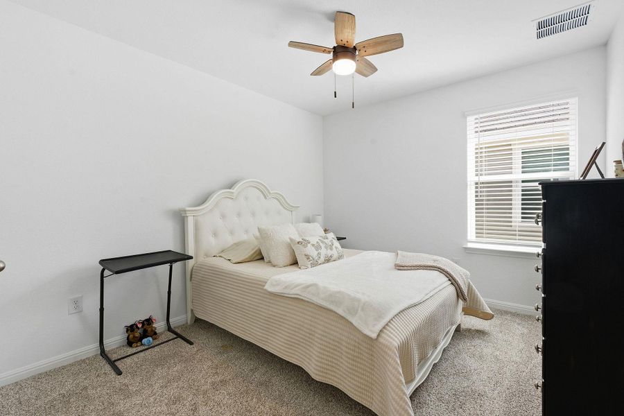 Bedroom with carpet and a ceiling fan