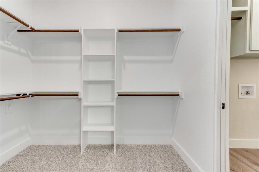 Spacious closet with light hardwood / wood-style floors