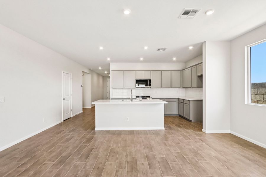 A kitchen with white cabinets.
