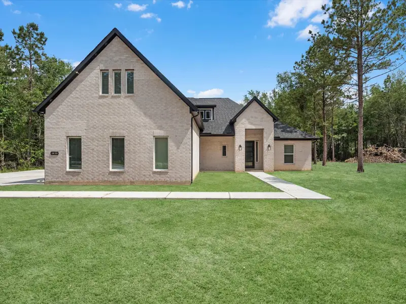 Front exterior of a new home in , Dayton, TX, highlighting curb appeal (Image 2).