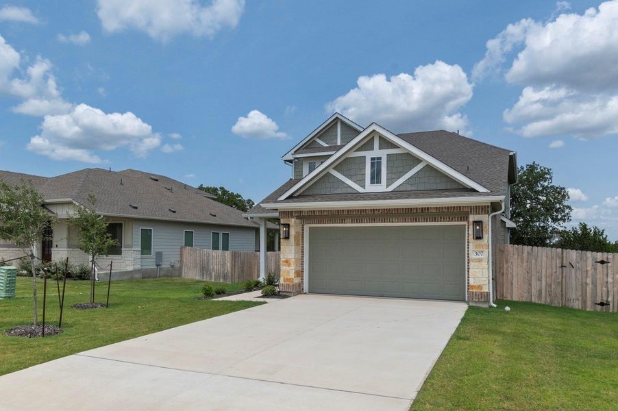 Front exterior of a new home in Grande Estates, Bertram, TX, highlighting curb appeal (Image 28). Front exterior of a new home in Grande Estates, Bertram, TX, highlighting curb appeal (Image 28).