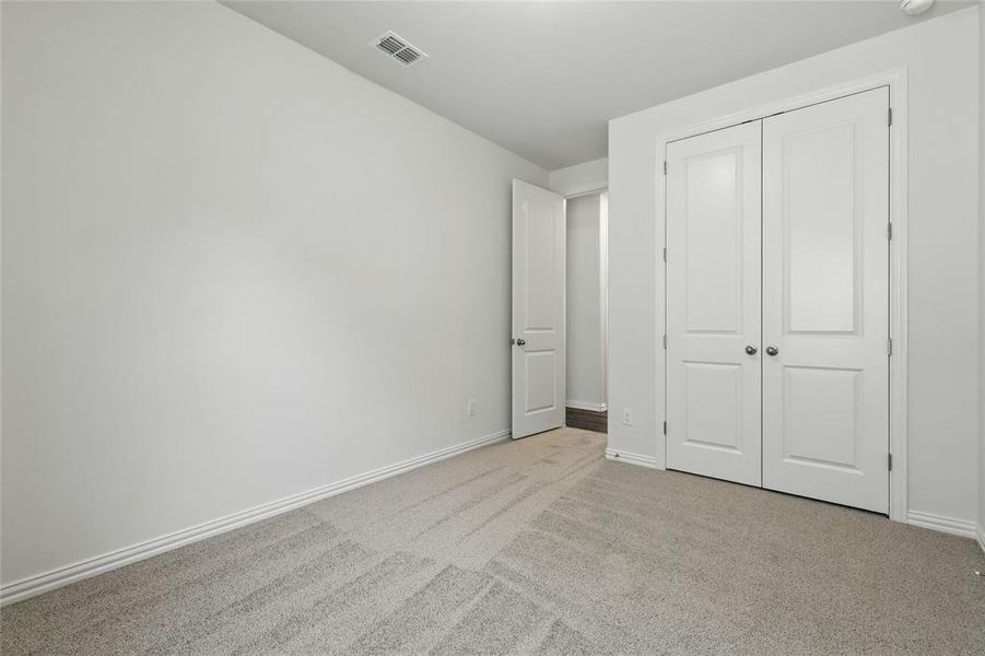 Unfurnished bedroom with carpet floors and a closet