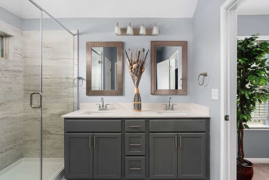 Primary bathroom with dual vanities. Primary bathroom with dual vanities.