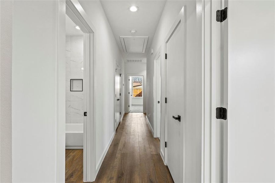 Hallway with dark hardwood / wood-style floors