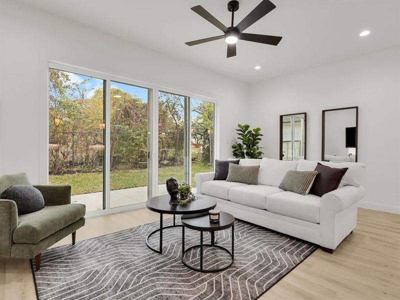 Living room featuring light hardwood / wood-style floors, plenty of natural light, and ceiling fan