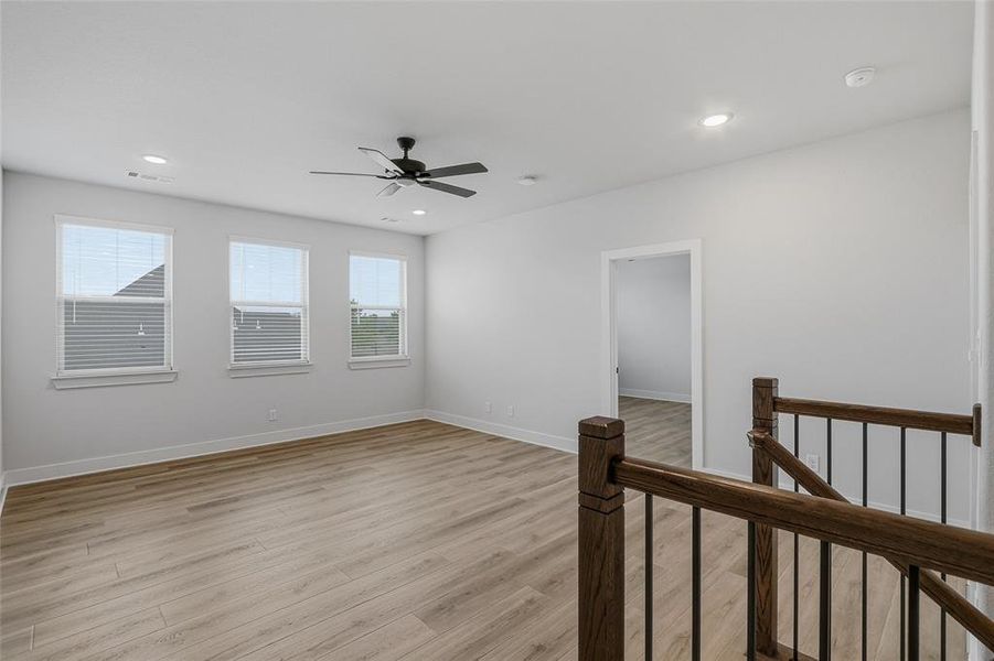 Empty room with light wood-style flooring, a ceiling fan, and recessed lighting