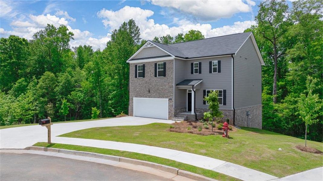 Front exterior of a new home in Locust Grove Station - Cedar Ridge, Locust Grove, GA, highlighting curb appeal (Image 1). Front exterior of a new home in Locust Grove Station - Cedar Ridge, Locust Grove, GA, highlighting curb appeal (Image 1).