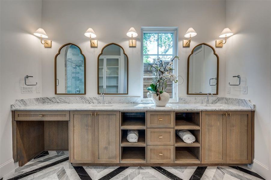 Primary Bathroom with inlaid floor details, double vanity, and a shower