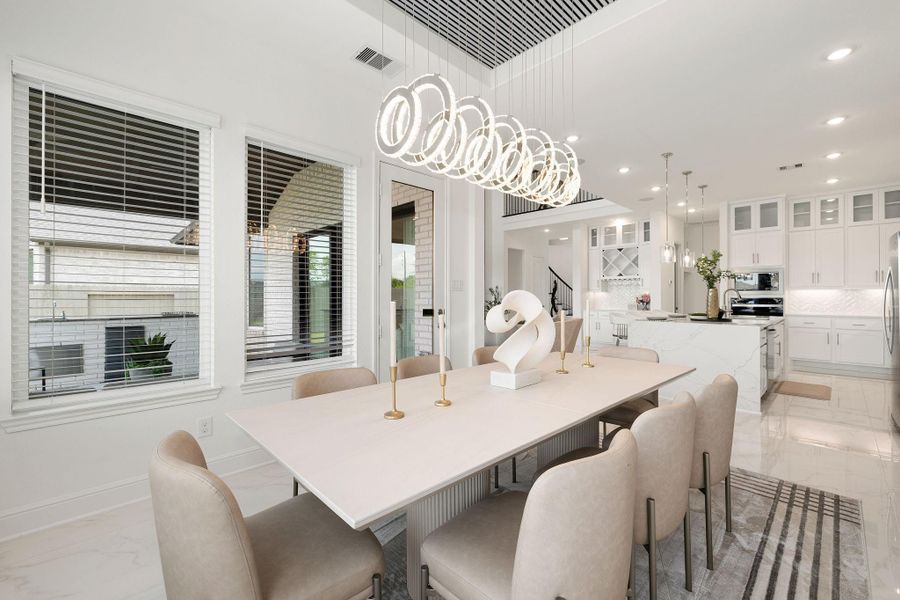 Elegant dining area with designer lighting and a refined setting for gatherings.
