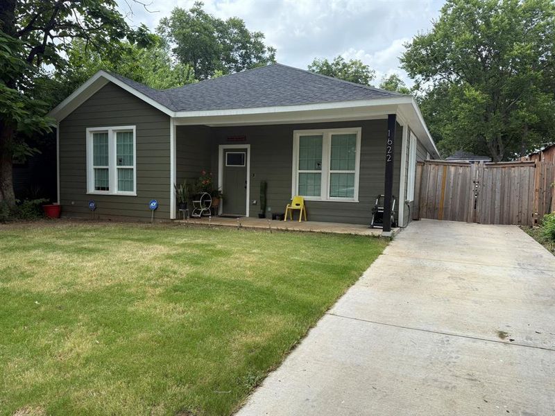 View of front of home with a shingled roof, a porch, concrete driveway, and a gate