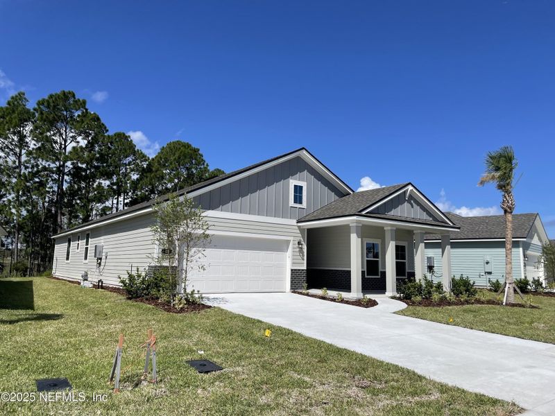 Front exterior of a new home in The Magnolia Series at Reserve East, Flagler Beach, FL, highlighting curb appeal (Image 20).