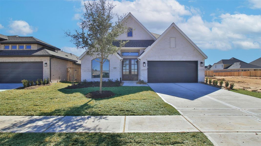 Front exterior of a new home in The Grand Prairie, Hockley, TX, highlighting curb appeal (Image 2).