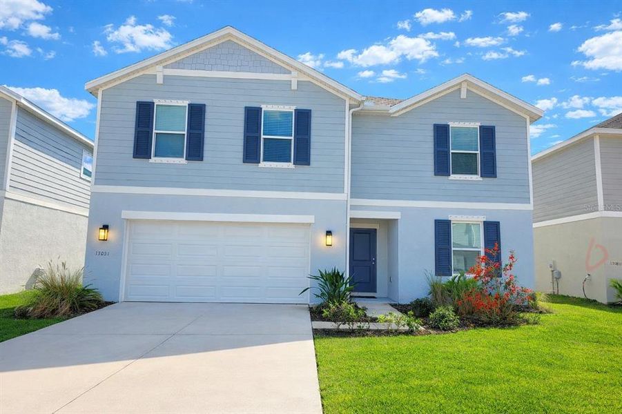 Front exterior of a new home in Broadleaf, Parrish, FL, highlighting curb appeal (Image 32).