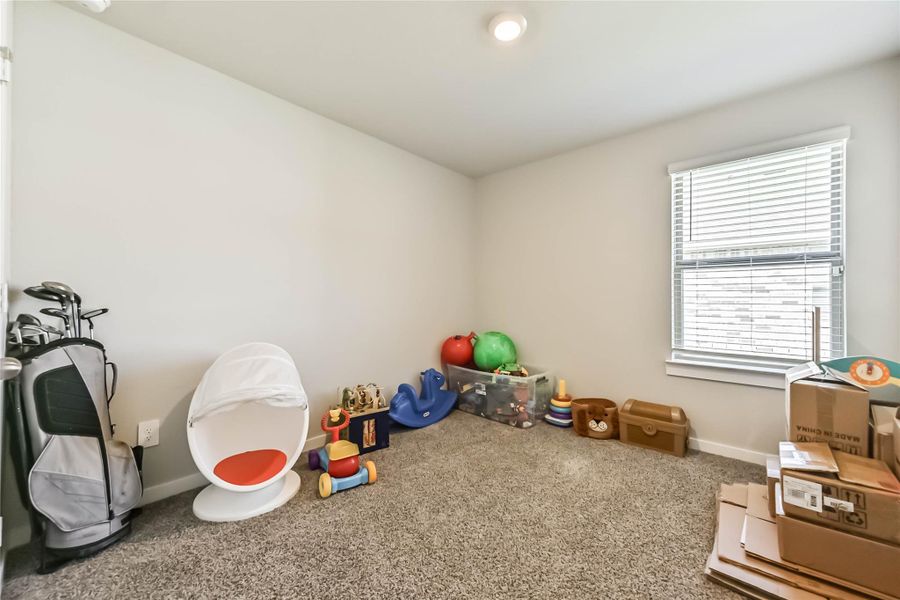 Versatile fourth bedroom with modern paint and plenty of room for work or play.