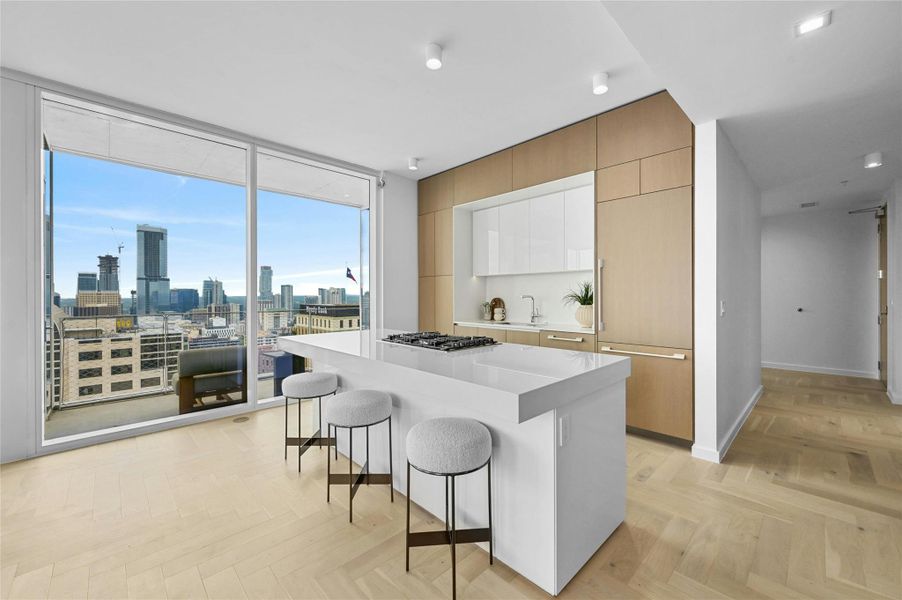 The kitchen is designed with a sleek, minimalist aesthetic, including cabinets that blend seamlessly into the walls, ensuring a clean and unobtrusive appearance. Plus, you can enjoy the panoramic city view while cooking or baking, adding to the kitchen's charm and functionality. The kitchen is designed with a sleek, minimalist aesthetic, including cabinets that blend seamlessly into the walls, ensuring a clean and unobtrusive appearance. Plus, you can enjoy the panoramic city view while cooking or baking, adding to the kitchen's charm and functionality.