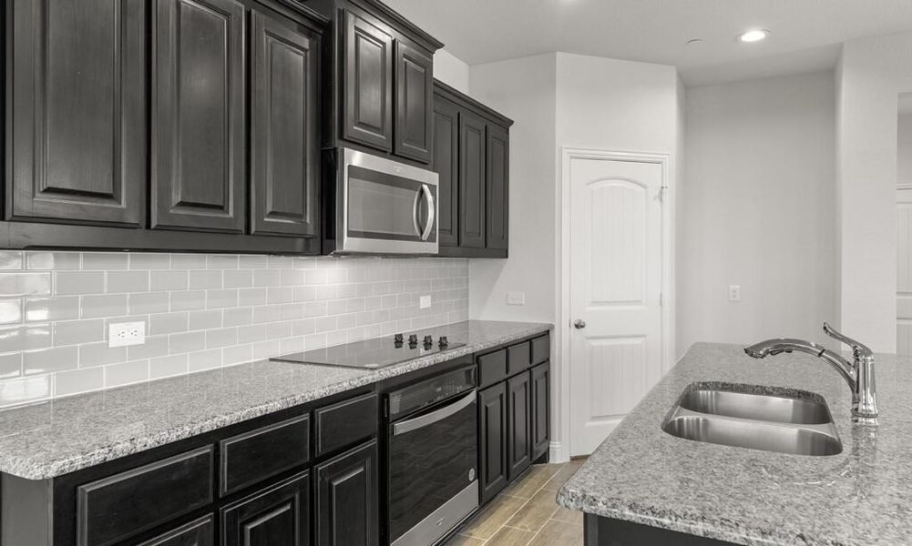 Representative exterior photo of a completed home built from the Granbury by Impression Homes in Main Street Village, Mansfield, TX (Image 7). Representative exterior photo of a completed home built from the Granbury by Impression Homes in Main Street Village, Mansfield, TX (Image 7).