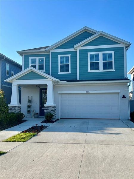 Front exterior of a new home in Persimmon Park - Garden Series, Wesley Chapel, FL, highlighting curb appeal (Image 1). Front exterior of a new home in Persimmon Park - Garden Series, Wesley Chapel, FL, highlighting curb appeal (Image 1).