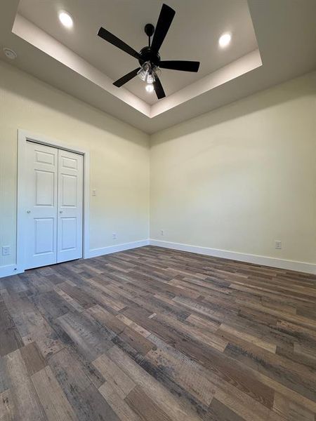 Hallway bedroom with custom designer ceiling fan and tray ceiling and 10' ft bedroom.