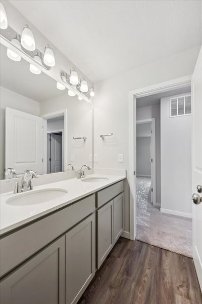 A bathroom with a large mirror.