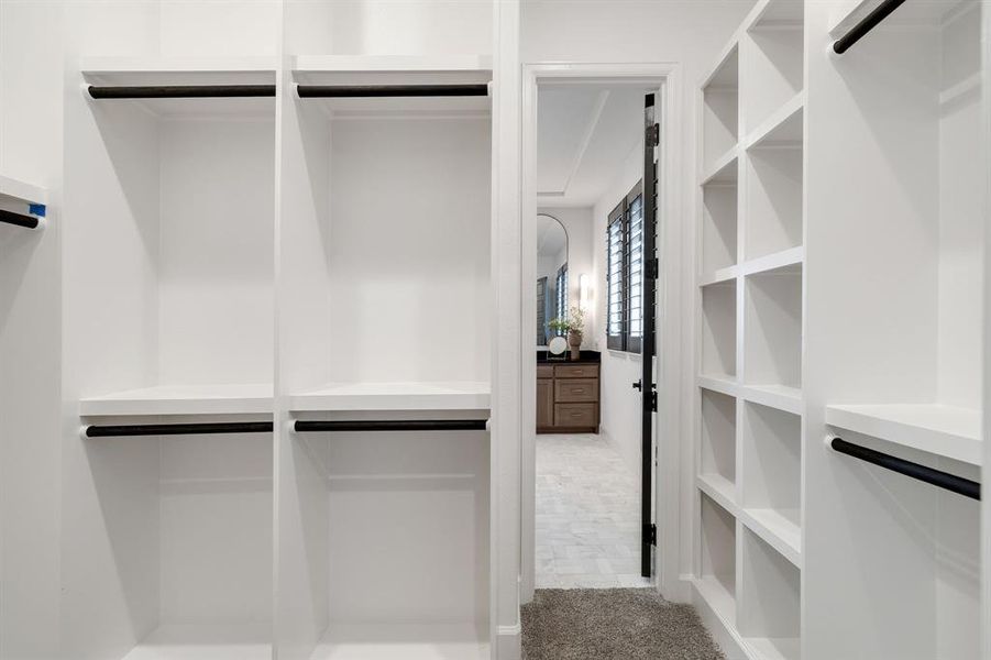 Spacious closet featuring light colored carpet Spacious closet featuring light colored carpet