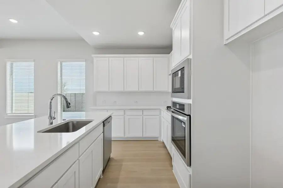Kitchen in the Stanley II home plan by Trophy Signature Homes – REPRESENTATIVE PHOTO