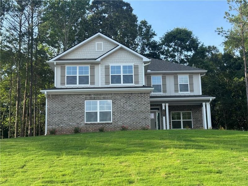 Front exterior of a new home in The Fields of Walnut Creek, Pendergrass, GA, highlighting curb appeal (Image 1). Front exterior of a new home in The Fields of Walnut Creek, Pendergrass, GA, highlighting curb appeal (Image 1).