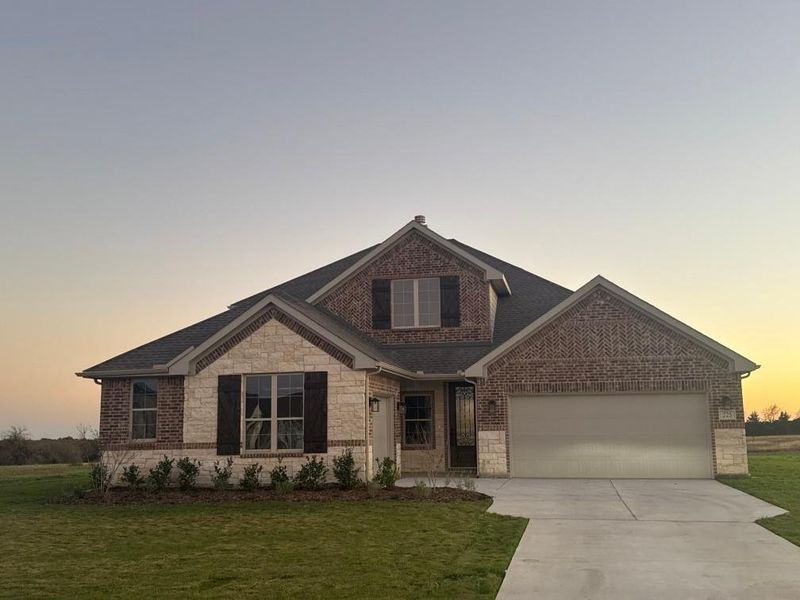 Front exterior of a new home in Fannin Ranch, Leonard, TX, highlighting curb appeal (Image 1). Front exterior of a new home in Fannin Ranch, Leonard, TX, highlighting curb appeal (Image 1).