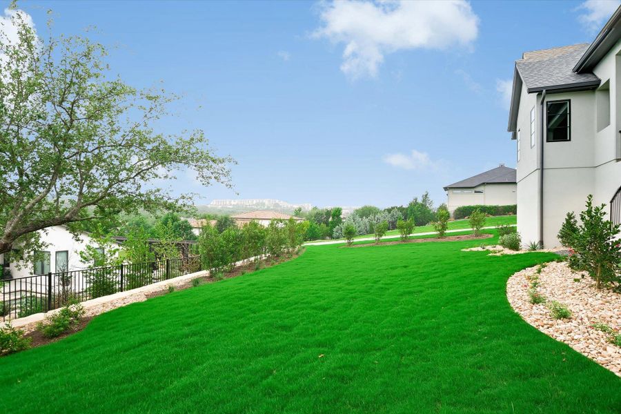 Expansive green lawn bordering a stucco exterior