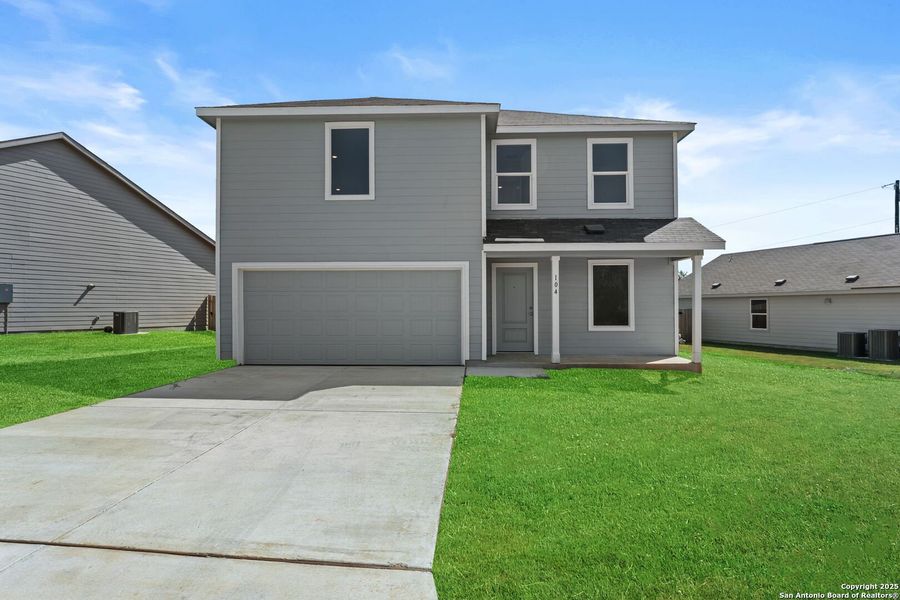 Front exterior of a new home in Lodi Grove, Floresville, TX, highlighting curb appeal (Image 1).