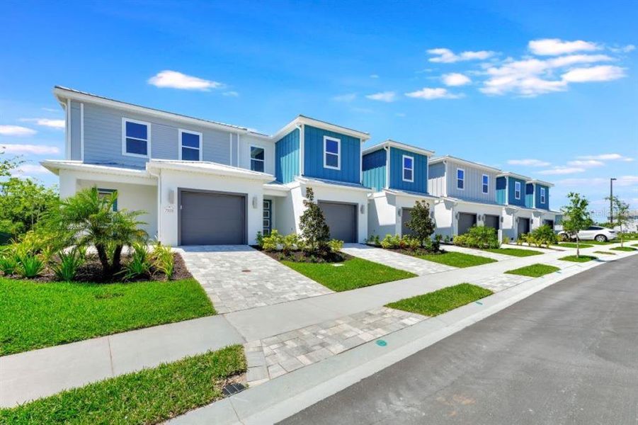 Front exterior of a new home in , Kissimmee, FL, highlighting curb appeal (Image 1).